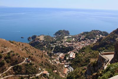 High angle view of townscape by sea against sky