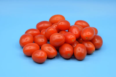 Close-up of tomatoes over blue background