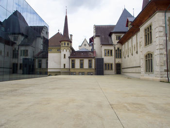 Buildings in town against sky