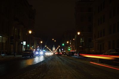 Illuminated city street at night