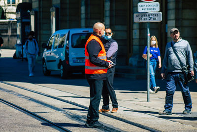 People standing on road in city