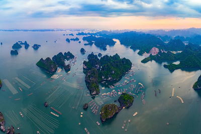 High angle view of city by sea against sky