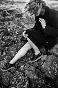 Woman sitting on rock