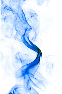 Close-up of blue smoke against white background