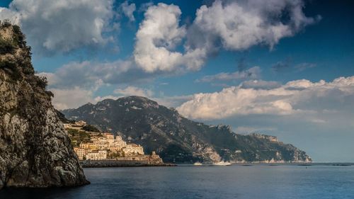 Scenic view of sea and mountains against sky