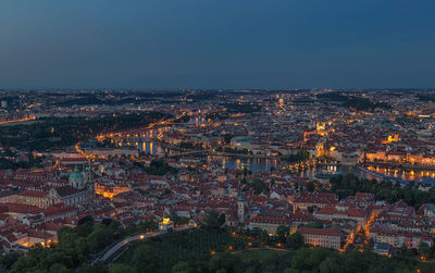 High angle view of illuminated buildings against sky at dusk