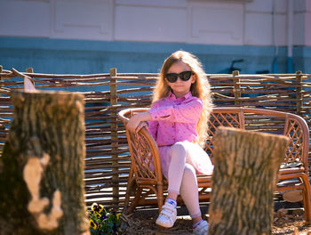 Portrait of young woman sitting on chair