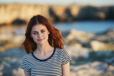 Portrait of smiling young woman standing outdoors