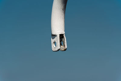 Low angle view of key against blue sky