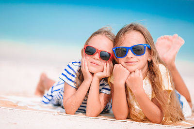 Portrait of happy girl wearing sunglasses at beach