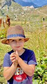 Portrait of young man standing on field child