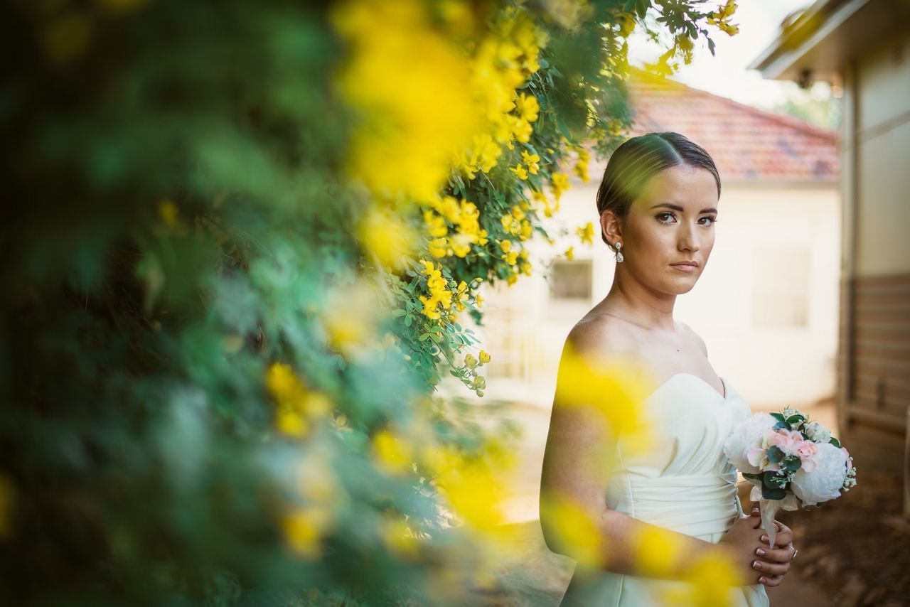 plant, one person, beautiful woman, standing, real people, young adult, flower, flowering plant, young women, beauty, portrait, leisure activity, women, front view, lifestyles, nature, adult, selective focus, looking at camera, fashion, outdoors, hairstyle