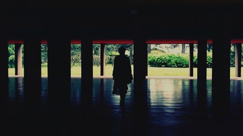 Silhouette man standing in corridor