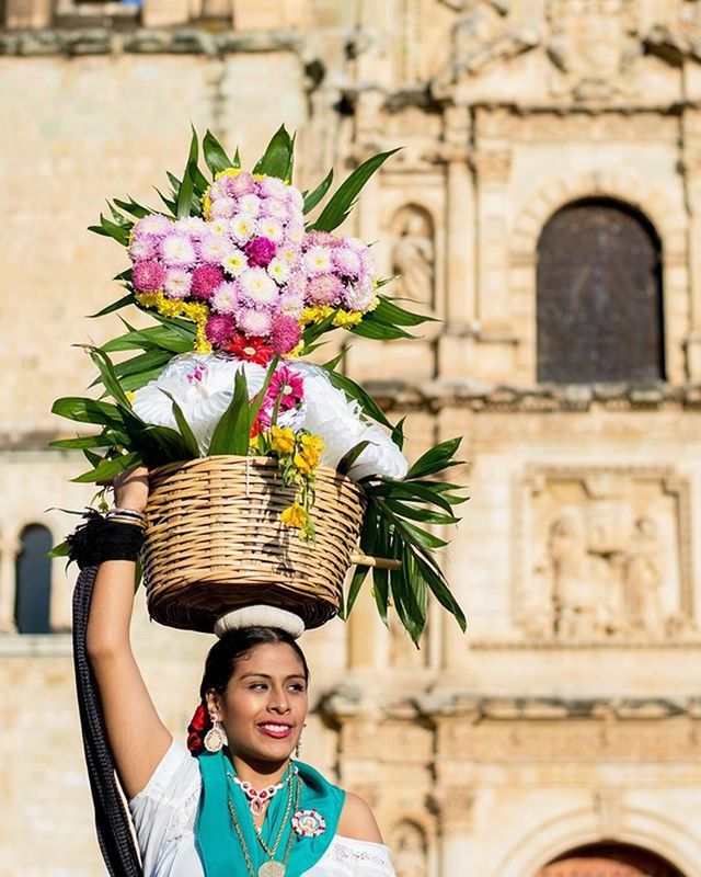 flower, focus on foreground, freshness, lifestyles, architecture, front view, built structure, holding, leisure activity, building exterior, fragility, religion, day, plant, outdoors, spirituality, smiling, childhood