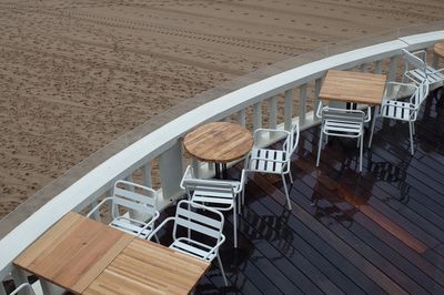 High angle view of empty chairs and table