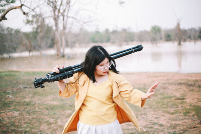 Rear view of woman standing on field