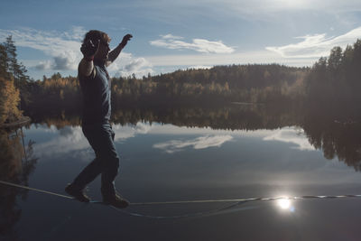 Full length of man standing on lake