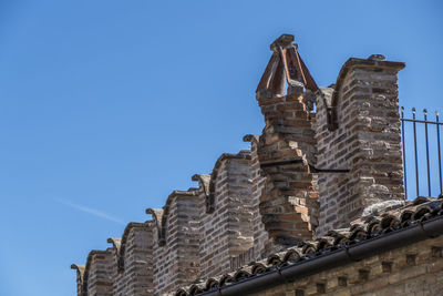 Historical center of corinaldo with tower, church, flowers and steps