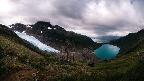 Scenic view of glacier and mountains against sky