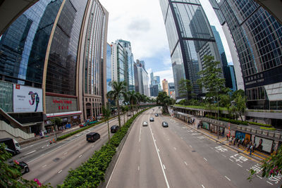 Panoramic view of city street and buildings against sky