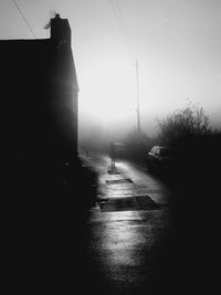 Empty road along buildings