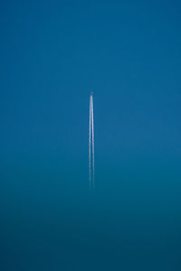 Low angle view of ship against clear blue sky