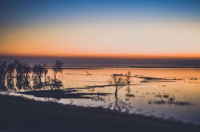 Scenic view of sea against sky during sunset