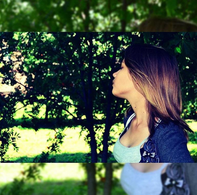 lifestyles, leisure activity, focus on foreground, person, young adult, casual clothing, young women, standing, long hair, tree, side view, looking away, park - man made space, waist up, contemplation, outdoors, day, nature