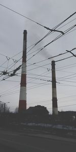 Low angle view of electricity pylon against sky