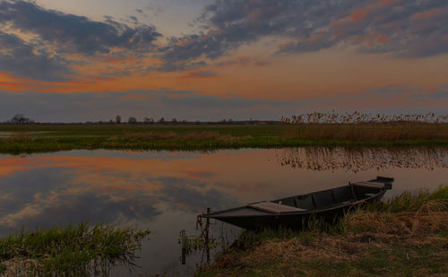 Scenic view of lake against sky during sunset