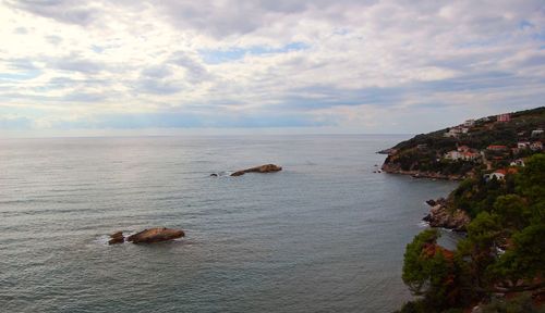 Scenic view of sea against cloudy sky