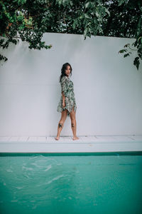 Full length of woman standing in swimming pool