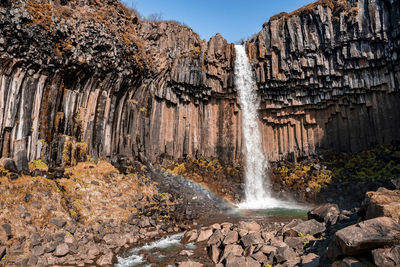 Beautiful cascades of svartifoss waterfall and flowing stream in national park