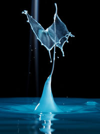 Close-up of water splashing over black background