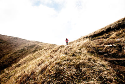 People on mountain against sky