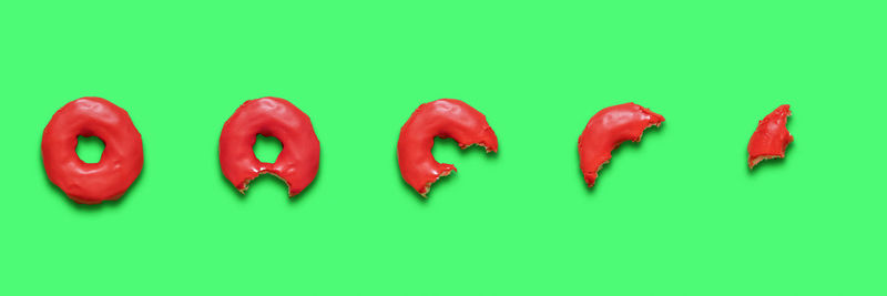 Close-up of red chili peppers over green background