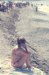 Young woman sitting on beach