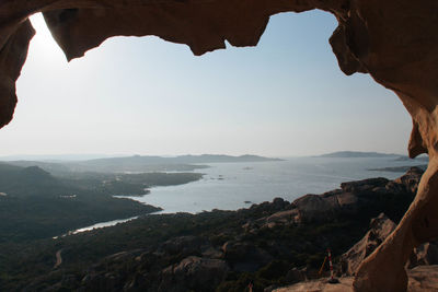 Scenic view of sea and mountains against sky