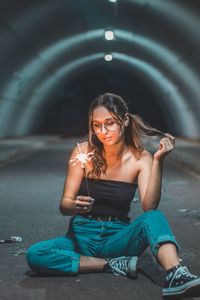 Portrait of smiling young woman sitting outdoors