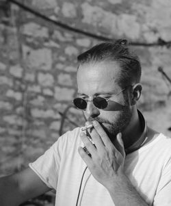 Portrait of man smoking cigarette outdoors