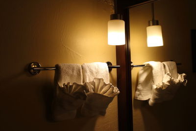 Towels hanging by illuminated light in room