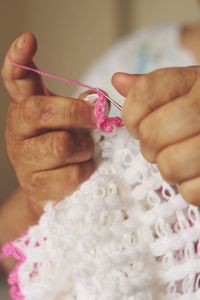 Midsection of woman making wool decoration
