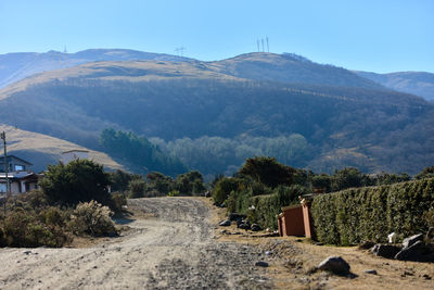 Dirt road leading towards mountains