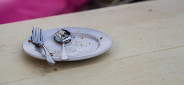 High angle view of cigarette in plate on table