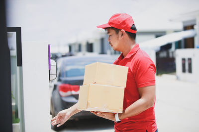 Side view of man working in box