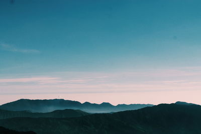 Scenic view of silhouette mountains against sky during sunset