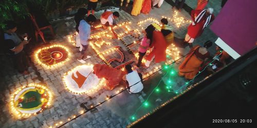 High angle view of people on table at night