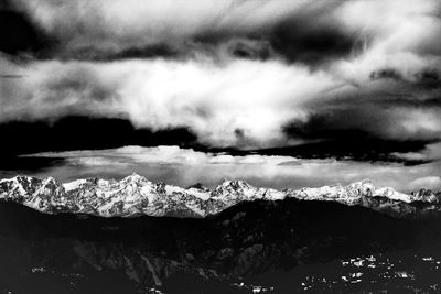 Scenic view of mountains against cloudy sky