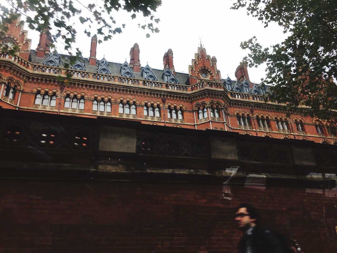 building exterior, architecture, built structure, low angle view, day, outdoors, history, travel destinations, tree, real people, sky, one person, young adult, people