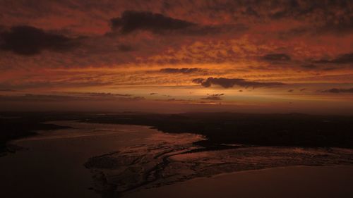 Scenic view of dramatic sky over sea during sunset